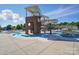 Community pool with a waterslide and shallow water area, surrounded by lounge chairs and trees at 333 Dudley Dr, Fort Mill, SC 29715