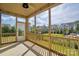 Screened-in porch with wooden railings offering backyard views and an overhead fan at 333 Dudley Dr, Fort Mill, SC 29715