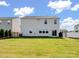 Well-maintained backyard featuring a lush lawn, black fence, and a two-story house with sliding glass doors at 3615 Slider Ter, Lancaster, SC 29720