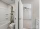 Clean bathroom featuring a shower-tub combo and neutral tile, conveniently located near the bedroom at 3615 Slider Ter, Lancaster, SC 29720
