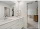 Bright bathroom with double sinks, white cabinets, and a view into an adjacent Bedroom at 3615 Slider Ter, Lancaster, SC 29720