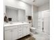 Bright bathroom with double vanity, white cabinets, and a glass-enclosed shower at 3615 Slider Ter, Lancaster, SC 29720