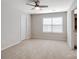 Spacious carpeted bedroom with a ceiling fan, a bright window, and an attached bathroom at 3615 Slider Ter, Lancaster, SC 29720