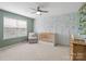 Charming Bedroom featuring decorative wallpaper, neutral carpet, and a cozy armchair near a bright window at 3615 Slider Ter, Lancaster, SC 29720