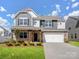 Beautiful two-story home with stone accents, covered porch, and well-manicured lawn at 3615 Slider Ter, Lancaster, SC 29720