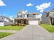Charming two-story home with a well-manicured lawn, a stone and siding facade, and an attached two-car garage at 3615 Slider Ter, Lancaster, SC 29720