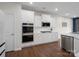 Modern kitchen with stainless steel appliances, white cabinets, and hardwood floors at 3615 Slider Ter, Lancaster, SC 29720