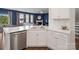 Modern kitchen featuring a stainless steel dishwasher, white cabinets, and light countertops at 3615 Slider Ter, Lancaster, SC 29720