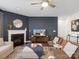 Stylish living room featuring a fireplace, dark accent wall, and modern furnishings on hardwood floors at 3615 Slider Ter, Lancaster, SC 29720