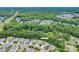An aerial view of a neighborhood with lush green trees surrounding beautiful homes and a view of 3666 Jacinta Court at 3666 Jacinta Ct, Tega Cay, SC 29708