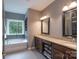 Bright bathroom with a soaking tub, dual vanity, and walk-in closet at 3666 Jacinta Ct, Tega Cay, SC 29708