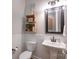 Small bathroom with pedestal sink, wainscotting and decorative baskets for storage at 3666 Jacinta Ct, Tega Cay, SC 29708