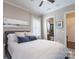 Cozy bedroom featuring a tufted headboard, soft textiles, and an en-suite bathroom at 3666 Jacinta Ct, Tega Cay, SC 29708