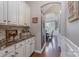 Hallway butler's pantry with custom cabinets and marble countertops at 3666 Jacinta Ct, Tega Cay, SC 29708