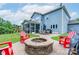 Spacious backyard featuring a fire pit, outdoor seating, dining area, and playset at 3666 Jacinta Ct, Tega Cay, SC 29708