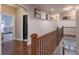 Upstairs hallway with decorative railing, wood floors and wainscotting at 3666 Jacinta Ct, Tega Cay, SC 29708