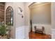 Inviting hallway featuring wood floors, stylish decor, and an arched doorway to a sitting area at 3666 Jacinta Ct, Tega Cay, SC 29708