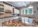 This kitchen features stone backsplash, stainless appliances, and stone countertops at 3666 Jacinta Ct, Tega Cay, SC 29708