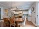 This kitchen features stainless steel appliances, a marble island and opens into the dining room at 3666 Jacinta Ct, Tega Cay, SC 29708