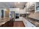 An open kitchen with stainless steel appliances and a large marble island at 3666 Jacinta Ct, Tega Cay, SC 29708