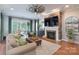 Comfortable living room features a fireplace, tv, hardwood floors, and stylish furniture at 3666 Jacinta Ct, Tega Cay, SC 29708