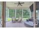 Inviting screened porch featuring a ceiling fan, outdoor seating, and views of the backyard at 3666 Jacinta Ct, Tega Cay, SC 29708