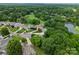 Wide aerial view of a neighborhood featuring homes, lush greenery, and a golf course by a pond at 4101 Fairway Downs Ct # 9, Charlotte, NC 28277