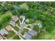 Aerial view showcases homes with manicured lawns, mature trees, and a pond alongside a golf course at 4101 Fairway Downs Ct # 9, Charlotte, NC 28277