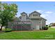 Back exterior featuring a deck, stairs, and well-maintained siding, set against a lush green backdrop at 4101 Fairway Downs Ct # 9, Charlotte, NC 28277