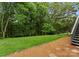 Grassy backyard, complemented by neat pine straw landscaping, offering a serene outdoor retreat at 4101 Fairway Downs Ct # 9, Charlotte, NC 28277