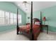 Bedroom with a four-poster bed, ceiling fan, and windows with plantation shutters at 4101 Fairway Downs Ct # 9, Charlotte, NC 28277