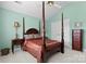 Bedroom featuring a four-poster bed, neutral carpet, and windows with plantation shutters at 4101 Fairway Downs Ct # 9, Charlotte, NC 28277