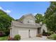 Exterior elevation of house showcasing the two-car garage and architectural details at 4101 Fairway Downs Ct # 9, Charlotte, NC 28277