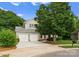 Landscaped home exterior features a two-car garage and manicured shrubbery at 4101 Fairway Downs Ct # 9, Charlotte, NC 28277