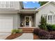 Inviting front porch with stone accents and a decorative wreath on the front door at 4101 Fairway Downs Ct # 9, Charlotte, NC 28277