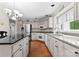 Spacious kitchen with light-colored cabinets, stainless appliances, and granite countertops at 4101 Fairway Downs Ct # 9, Charlotte, NC 28277