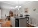 Open kitchen flows into dining area with an island, chairs and wine cooler at 4101 Fairway Downs Ct # 9, Charlotte, NC 28277