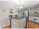 Kitchen features a black island, stainless steel appliances, and hardwood floors at 4101 Fairway Downs Ct # 9, Charlotte, NC 28277