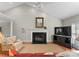 Cozy living room featuring a fireplace, ceiling fan, and comfortable seating arrangement at 4101 Fairway Downs Ct # 9, Charlotte, NC 28277