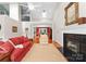 Spacious living room flows into the dining area, featuring a fireplace and hardwood floors at 4101 Fairway Downs Ct # 9, Charlotte, NC 28277