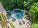 Aerial view showcasing a backyard oasis with a beautiful pool, lush landscaping, and outdoor seating areas at 4319 Sailview Dr, Denver, NC 28037