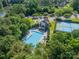Aerial view of a community clubhouse with a swimming pool, tennis courts, and lush landscaping at 4319 Sailview Dr, Denver, NC 28037