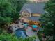 Aerial view of a backyard with a patio, outdoor seating, manicured landscaping, and a swimming pool at 4319 Sailview Dr, Denver, NC 28037