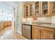 A built-in bar includes a mini-fridge, glass cabinets, granite countertop and wood floors at 4319 Sailview Dr, Denver, NC 28037