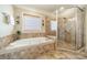 Bathroom with tile floors, soaking tub, glass shower and travertine tile at 4319 Sailview Dr, Denver, NC 28037