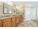 Bathroom with double sinks, granite counters, wood cabinets and tile floors at 4319 Sailview Dr, Denver, NC 28037