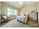 Well-lit bedroom with a vaulted ceiling, a rocking chair, and a yellow and blue patterned bedspread at 4319 Sailview Dr, Denver, NC 28037