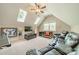 Bright bonus room featuring skylights, built-in storage, and comfortable seating for entertainment at 4319 Sailview Dr, Denver, NC 28037