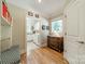 Inviting hallway with built-in bench, dresser, and views into the bright laundry room at 4319 Sailview Dr, Denver, NC 28037