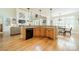 An eat-in kitchen includes wood floors, granite counters and an island with a sink and dishwasher at 4319 Sailview Dr, Denver, NC 28037